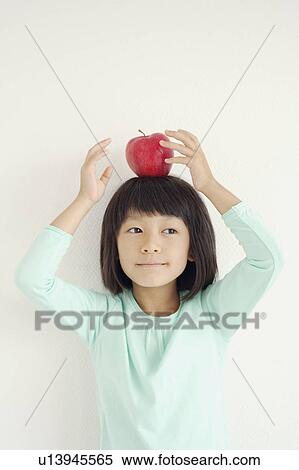 Young Girl Holding Apple on Her Head View Large Photo Image Stock Photography - Young Girl Holding Apple on Her Head. Fotosearch