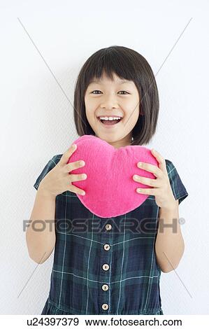 Stock Photo - Young Girl Holding Love Heart. Fotosearch
