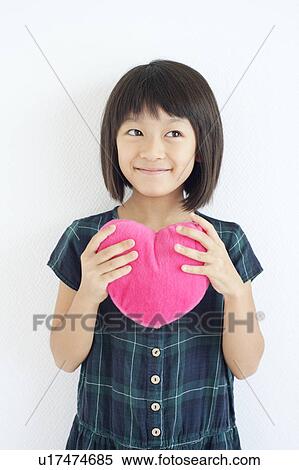 Stock Photography - Young Girl Holding Love Heart. Fotosearch