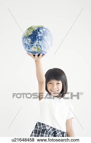 Stock Photo - Young Girl Holding Up The Earth. Fotosearch