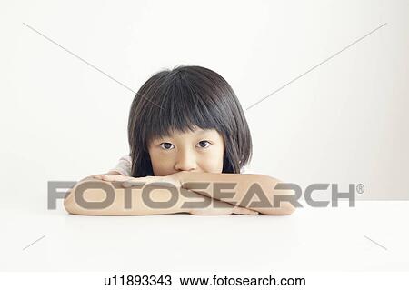 Stock Image - Young Girl Resting on Table. Fotosearch