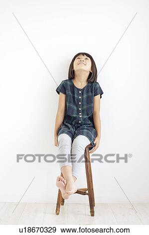 Young Girl Sitting on Stool and Looking Up View Large Photo Image Stock Photo - Young Girl Sitting on Stool and Looking Up. Fotosearch