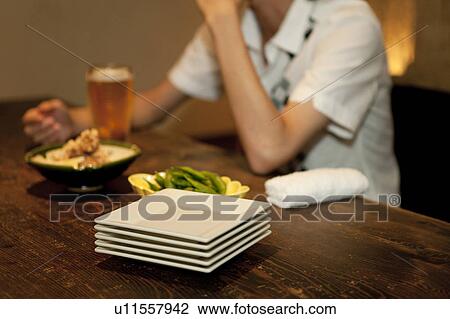 Young man at a bar View Large Photo Image Stock Image - Young man at a bar. Fotosearch