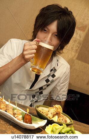 Stock Photo - Young man at a bar. Fotosearch