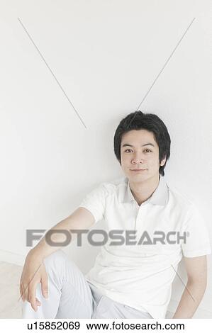 Stock Photo - Young man looking at camera. Fotosearch