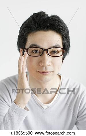 Stock Image - Young man wearing glasses. Fotosearch