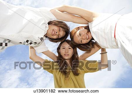 Young people in a huddle, low angle view View Large Photo Image Stock Image - Young people in a huddle, low angle view. Fotosearch