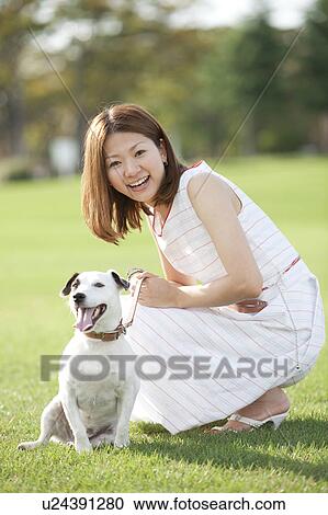 Young woman and dog looking at camera View Large Photo Image Stock Image - Young woman and dog looking at camera. Fotosearch