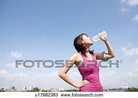 Young woman drinking water View Large Photo Image Stock Image - Young woman drinking water. Fotosearch