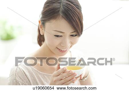 Picture - Young Woman Having Tea. Fotosearch