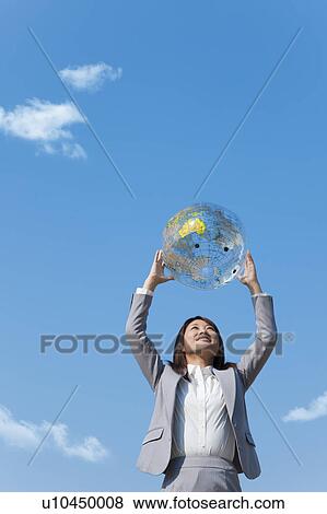 Young woman holding a globe View Large Photo Image Stock Photo - Young woman holding a globe. Fotosearch