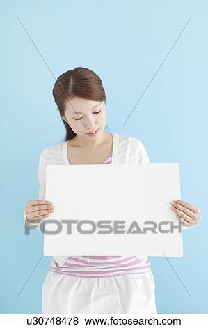 Young Woman Holding Blank Message View Large Photo Image Stock Photo - Young Woman Holding Blank Message. Fotosearch