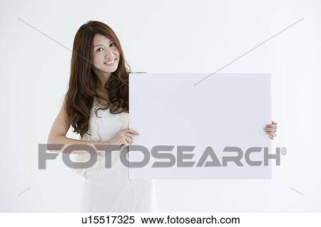 Young woman holding cardboard View Large Photo Image Stock Photography - Young woman holding cardboard. Fotosearch
