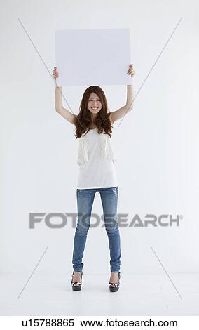 Young woman holding cardboard View Large Photo Image Stock Photography - Young woman holding cardboard. Fotosearch