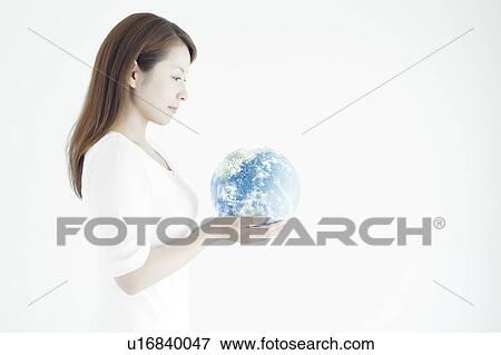 Stock Photo - Young Woman Holding The Earth. Fotosearch