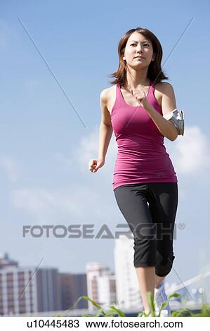 Stock Image - Young Woman jogging. Fotosearch