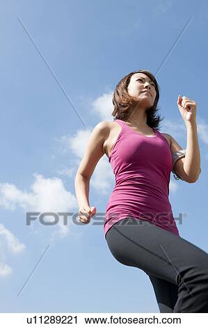 Stock Image - Young Woman jogging. Fotosearch