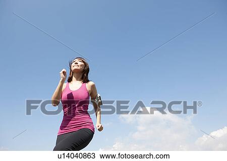 Stock Image - Young Woman jogging. Fotosearch