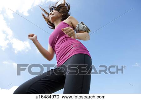 Stock Image - Young Woman jogging. Fotosearch