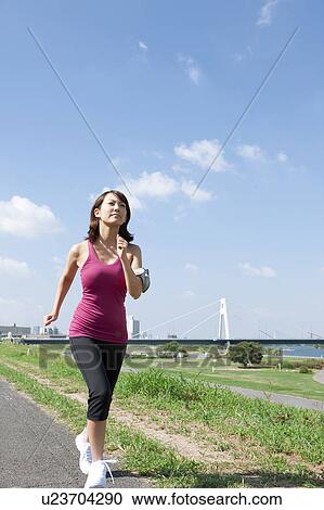 Stock Image - Young Woman jogging. Fotosearch