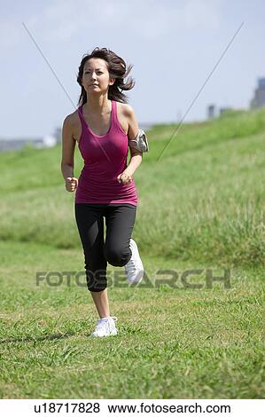 Young Woman jogging View Large Photo Image Stock Photo - Young Woman jogging. Fotosearch
