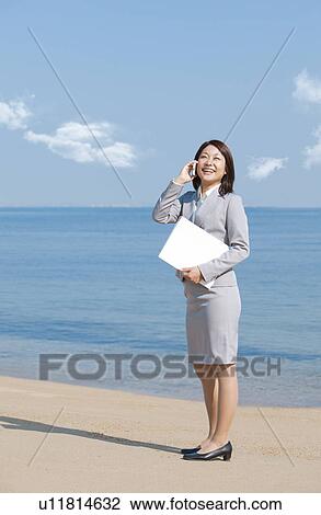 Young woman on cell phone View Large Photo Image Stock Image - Young woman on cell phone. Fotosearch
