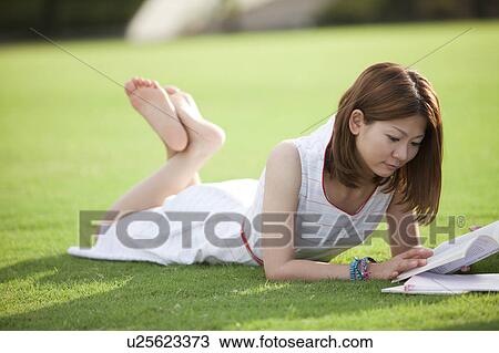 Young woman reading a book View Large Photo Image Stock Image - Young woman reading a book. Fotosearch