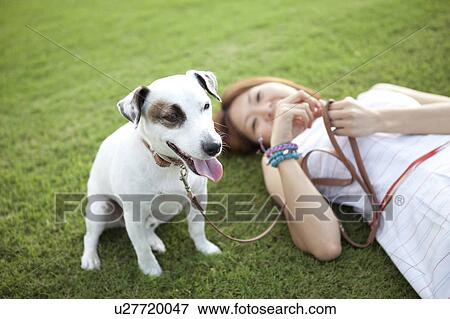 Young woman relaxing with a dog View Large Photo Image Stock Photo - Young woman relaxing with a dog. Fotosearch