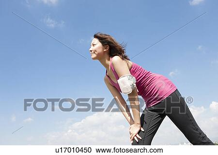 Stock Image - Young woman stretching. Fotosearch