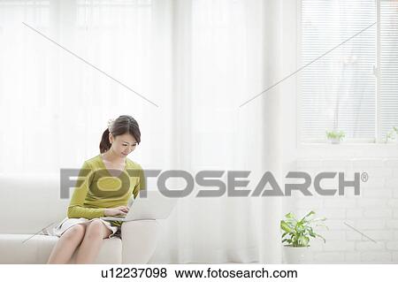 Stock Photo - Young Woman Using Laptop. Fotosearch