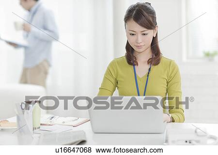 Stock Photo - Young Woman Using Laptop. Fotosearch