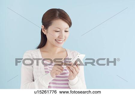 Young Woman Using Mobile Phone View Large Photo Image Stock Photograph - Young Woman Using Mobile Phone. Fotosearch