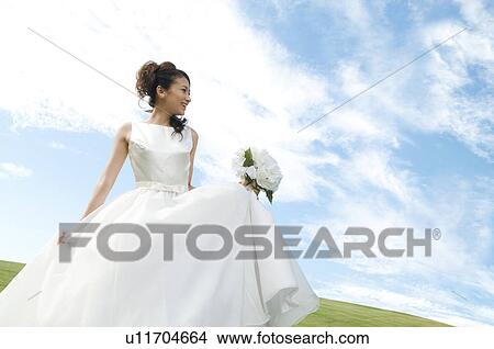 Picture - Young woman wearing a wedding dress. Fotosearch