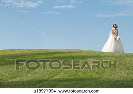 Young woman wearing a wedding dress View Large Photo Image Picture - Young woman wearing a wedding dress. Fotosearch