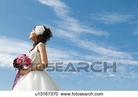 Young woman wearing a wedding dress View Large Photo Image Stock Image - Young woman wearing a wedding dress. Fotosearch