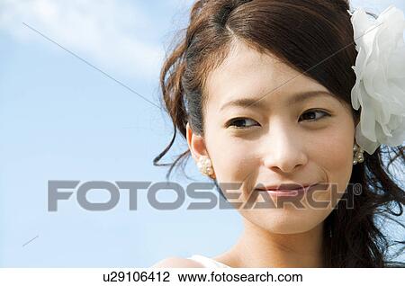 Stock Image - Young woman wearing a wedding dress. Fotosearch