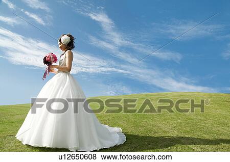 Young woman wearing a wedding dress View Large Photo Image Stock Photo - Young woman wearing a wedding dress. Fotosearch