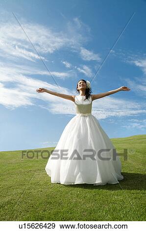 Stock Photo - Young woman wearing a wedding dress. Fotosearch
