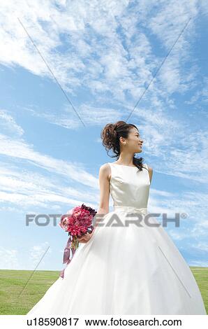 Stock Photo - Young woman wearing a wedding dress. Fotosearch
