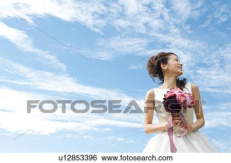 Young woman wearing a wedding dress View Large Photo Image Stock Photograph - Young woman wearing a wedding dress. Fotosearch