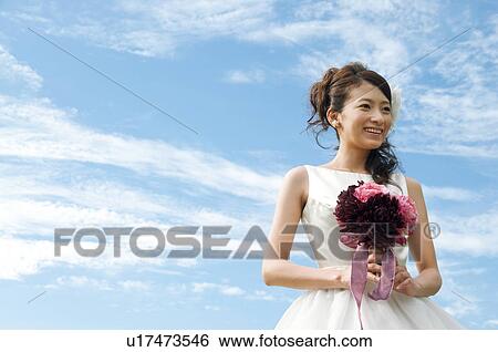 Stock Photograph - Young woman wearing a wedding dress. Fotosearch