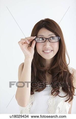 Picture - Young woman wearing glasses. Fotosearch