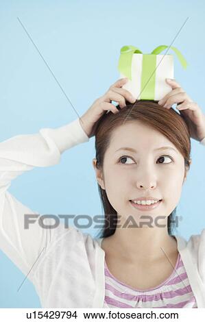 Young Woman With Gift on Her Head View Large Photo Image Picture - Young Woman With Gift on Her Head. Fotosearch