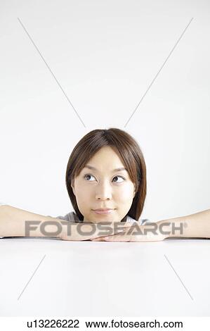Young woman with hand on chin View Large Photo Image Stock Image - Young woman with hand on chin. Fotosearch