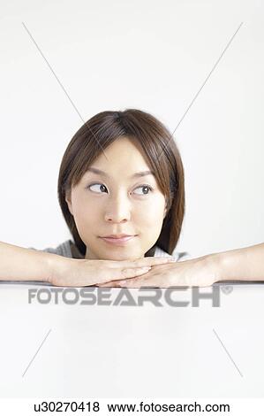 Young woman with hand on chin View Large Photo Image Stock Photo - Young woman with hand on chin. Fotosearch