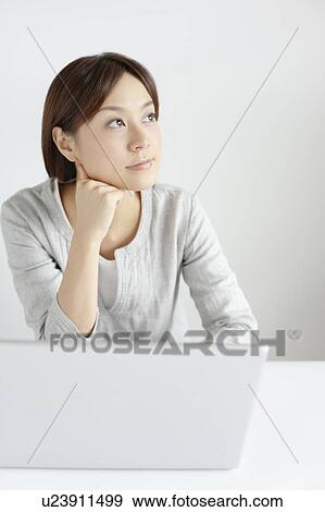 Stock Photo - Young woman with laptop. Fotosearch