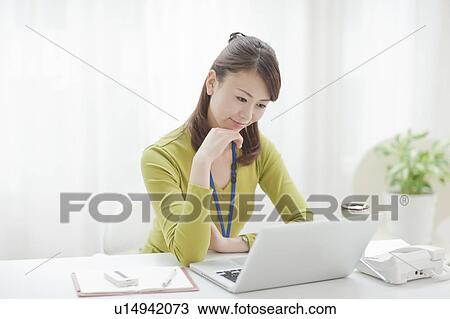 Young Woman Working at Desk View Large Photo Image Stock Image - Young Woman Working at Desk. Fotosearch
