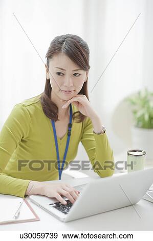Young Woman Working at Desk View Large Photo Image Stock Photo - Young Woman Working at Desk. Fotosearch