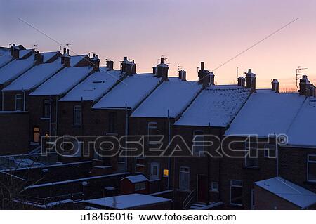Aerial view of row housing, Newton Cap Bank, Bishop Auckland, Northern England, with pink sky, snow on line of rooftops, some windows illuminated, at dusk. View Large Photo Image Stock Photograph - Aerial view of row housing, Newton Cap Bank, Bishop Auckland, Northern England, with pink sky, snow on line of rooftops, some windows illuminated, at dusk.. Fotosearch