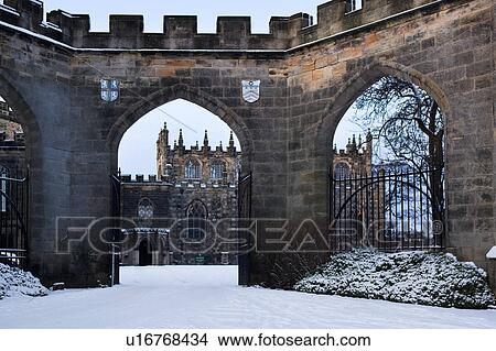 Bishop's Palace: view of arched entranceway and forecourt, with chapel beyond, in late afternoon sunlight, winter with snow and blue sky, Bishop Auckland, Northern England View Large Photo Image Picture - Bishop's Palace: view of arched entranceway and forecourt, with chapel beyond, in late afternoon sunlight, winter with snow and blue sky, Bishop Auckland, Northern England. Fotosearch